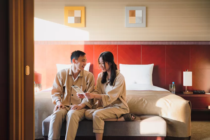 Couple planning their travel itinerary at Hotel Okura Fukuoka Guestroom 